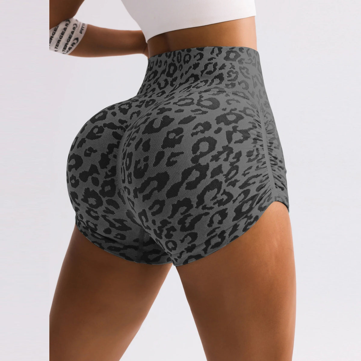 Gray high-waist athletic shorts featuring a black leopard print, scrunch back, and form-fitting workout design.