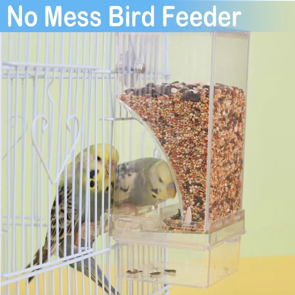 Clear acrylic, no-mess bird feeder attached to a white cage with parakeets eating seed from the tray.