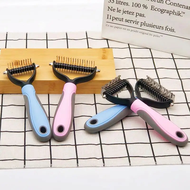 Four pet grooming dematting rakes with blue and pink handles on a grid-patterned surface.