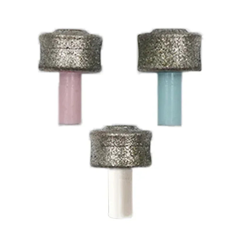 Three replacement abrasive grinding heads for a pet nail trimmer, featuring pink, blue, and white plastic stems.