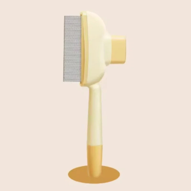 Cream-coloured pet grooming brush with a fine metal comb, long ergonomic handle and stable base on a beige background.