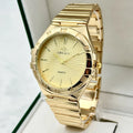 Gold luxury quartz wristwatch with textured dial, roman numerals on bezel, and a linked metal band.