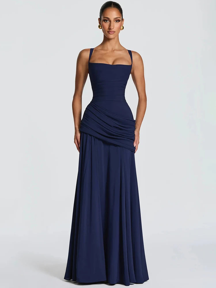Navy blue sleeveless maxi dress with a square neckline, fitted bodice, draped hip detailing, and pleated skirt.