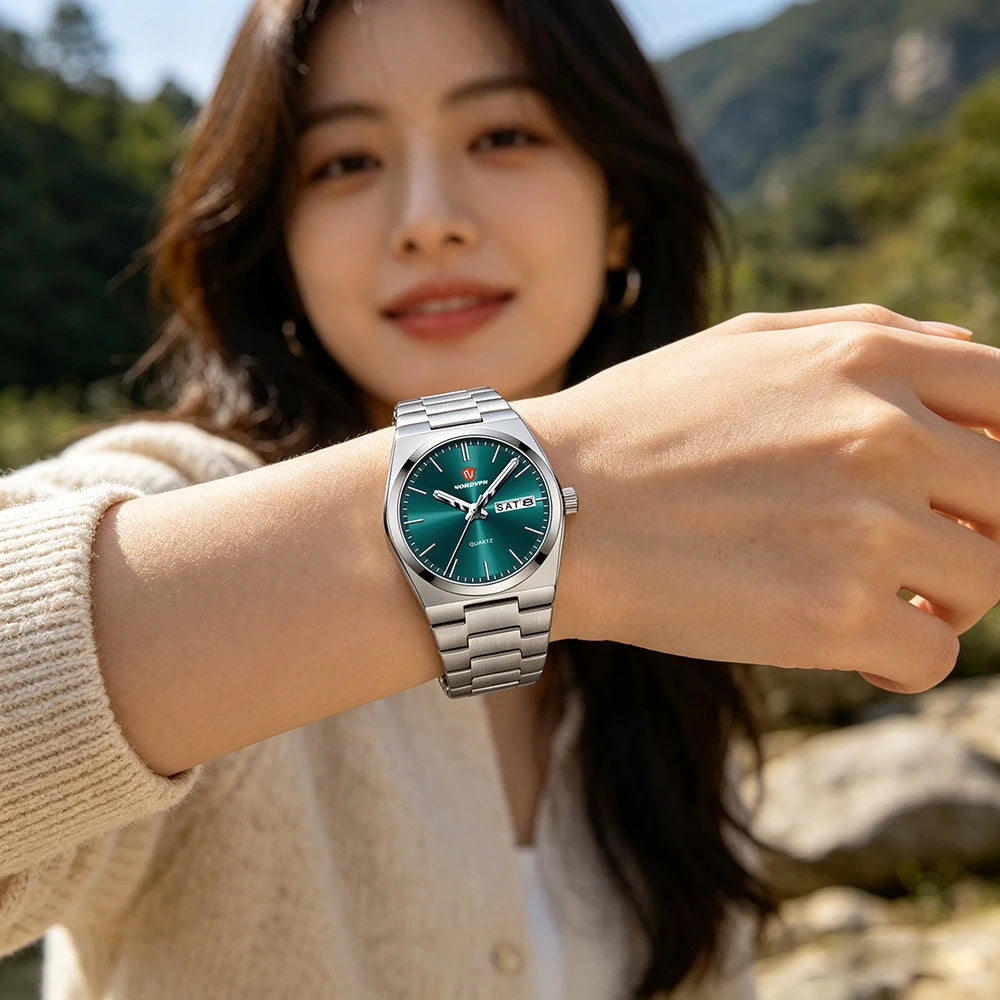 Elegant women’s quartz watch with a slim silver bracelet and a striking emerald-green sunray dial.