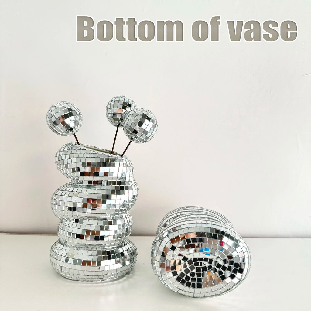 Silver disco ball flower vase with reflective mirrored tiles, shown with a matching vase lying on its side.