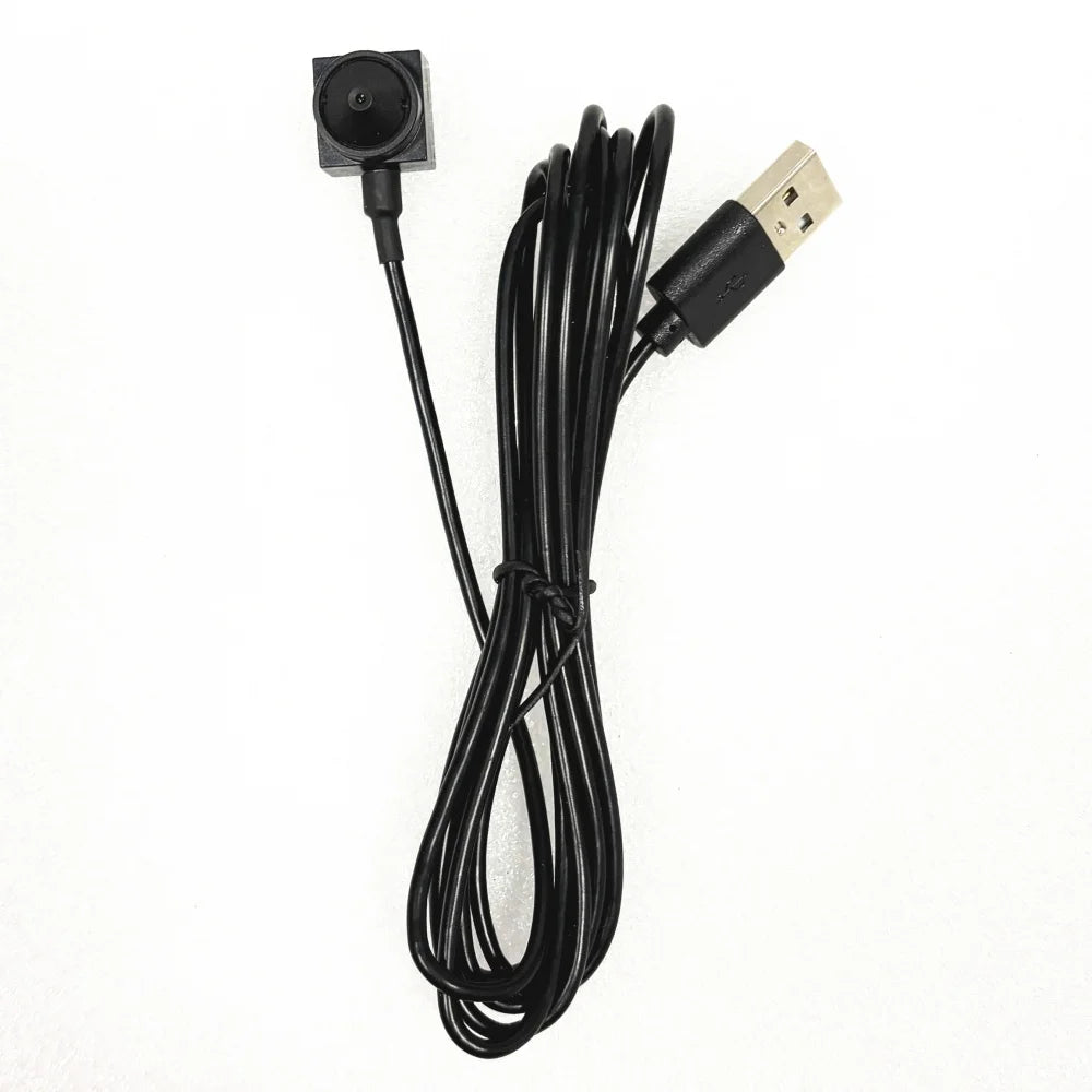 Black mini camera with a wired USB connection and square lens housing on a white background.