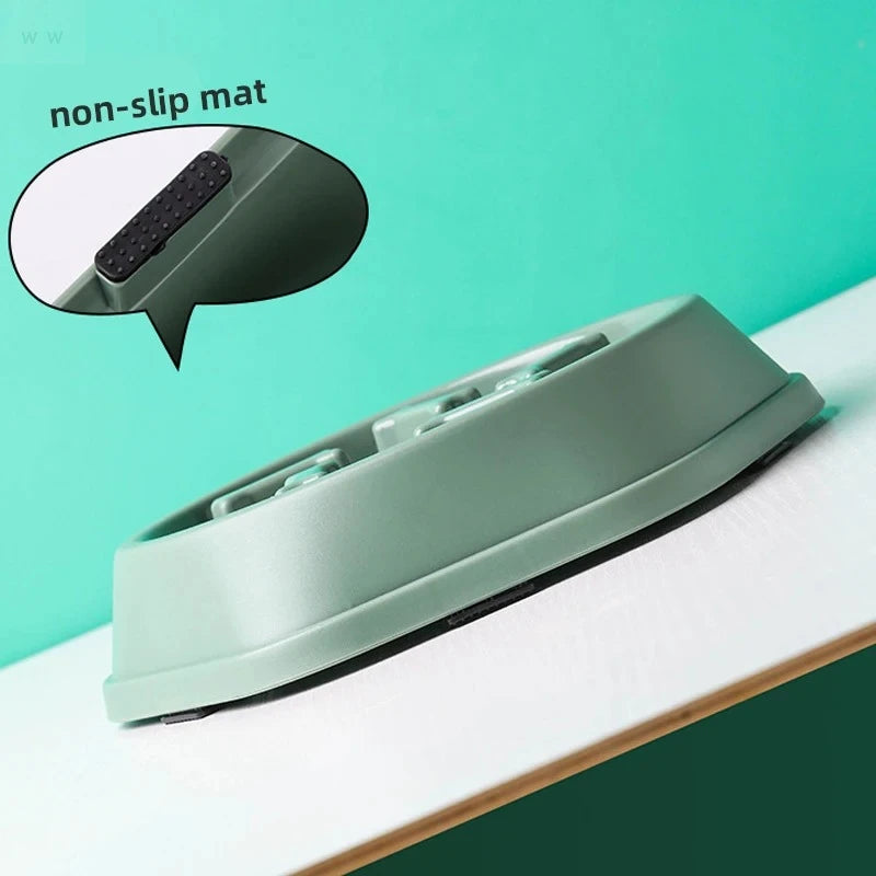 Sage green slow-feeder pet bowl with internal ridges and black non-slip rubber pads on the base.