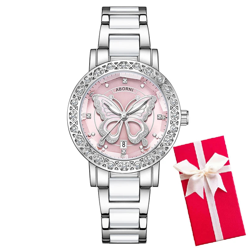 Luxury women's watch with a pale pink butterfly dial, crystal-set bezel, and polished silver and white link strap.