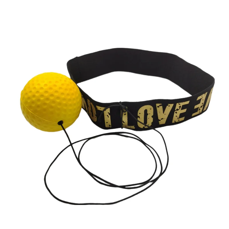 A yellow boxing reflex ball attached by a black elastic cord to a black headband with gold text.