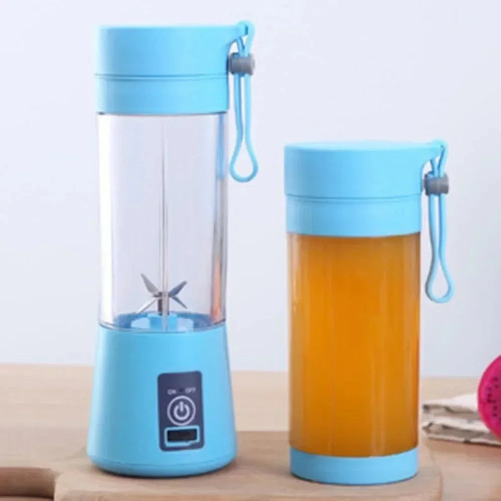 Two light blue portable electric blenders with a clear plastic cup and a carry strap, one filled with orange juice.
