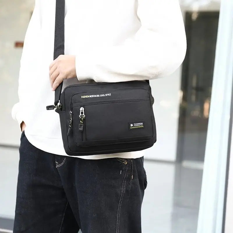 Black men's crossbody bag with an adjustable shoulder strap, front zipped pocket, and a clean, versatile design.