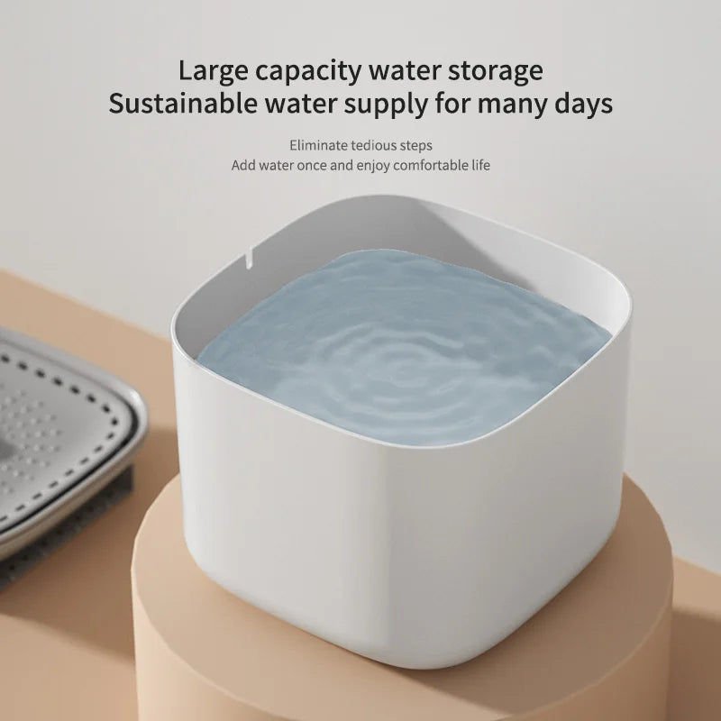 Minimalist white square water storage tank filled with water, positioned on a rounded beige pedestal.