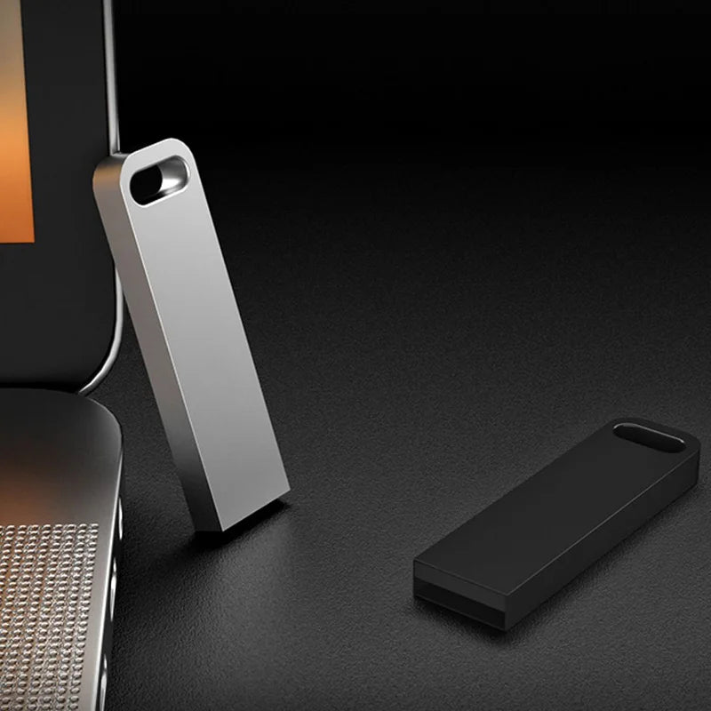 Sleek silver and black metal USB flash drives with a minimalist design and built-in lanyard hole.