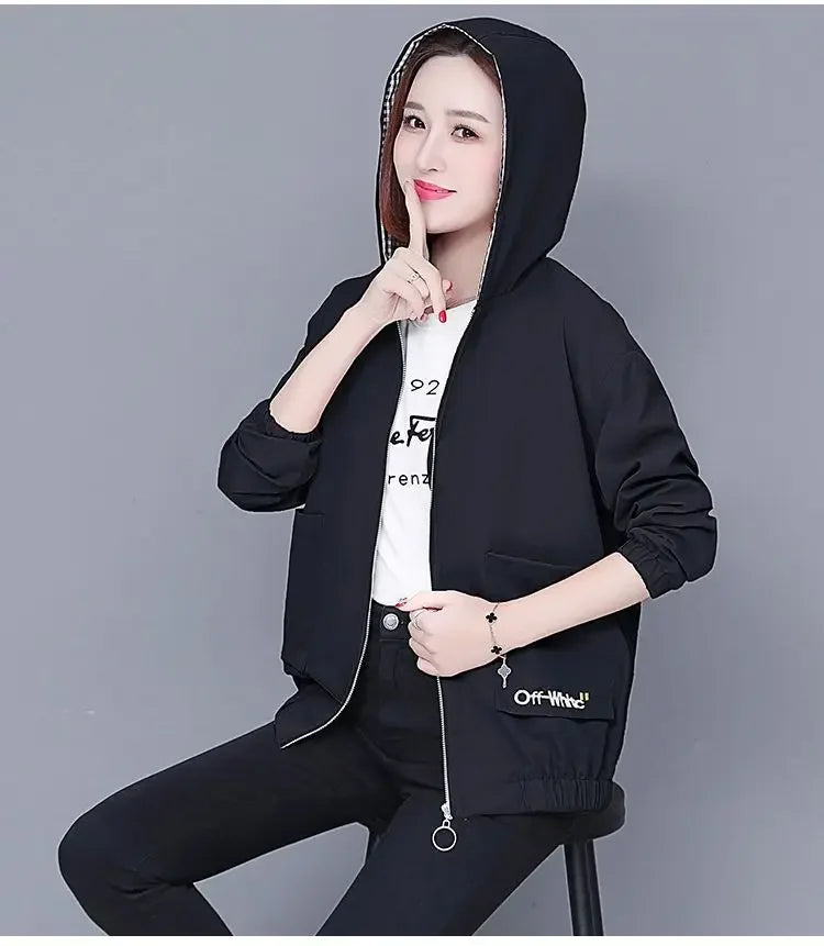 Black zip-up hooded jacket with a plaid-lined hood, elasticated cuffs, and side pockets, worn over a white t-shirt.