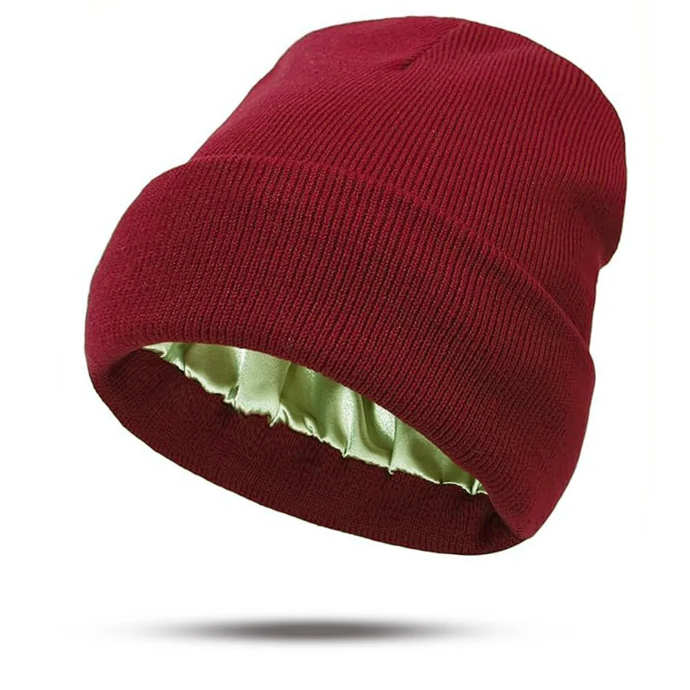Deep red knitted beanie hat featuring a soft, pale green satin lining.