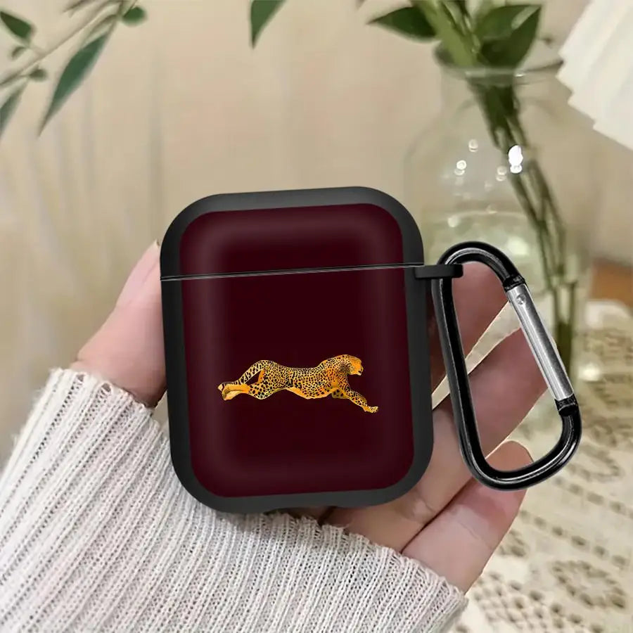 Dark burgundy protective silicone AirPods case with a sprinting leopard design and a black metal carabiner clip.
