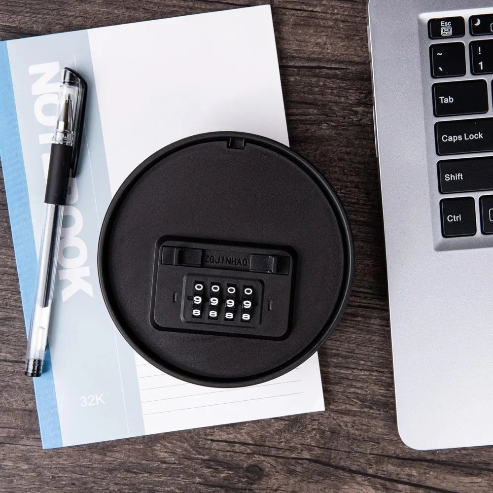 Black plastic circular security safe with a four-digit mechanical combination lock.