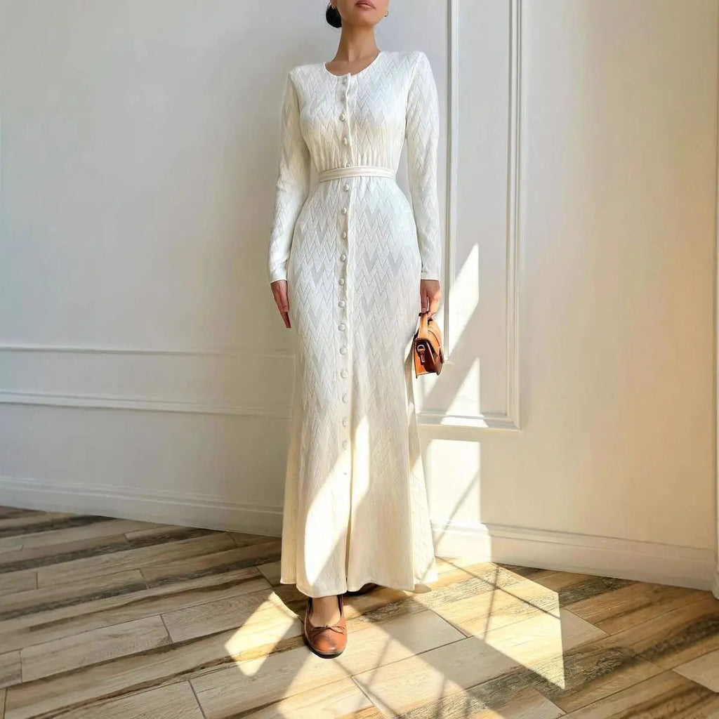 Cream, long-sleeved maxi dress with a textured chevron pattern, button-down front, and fitted waist.