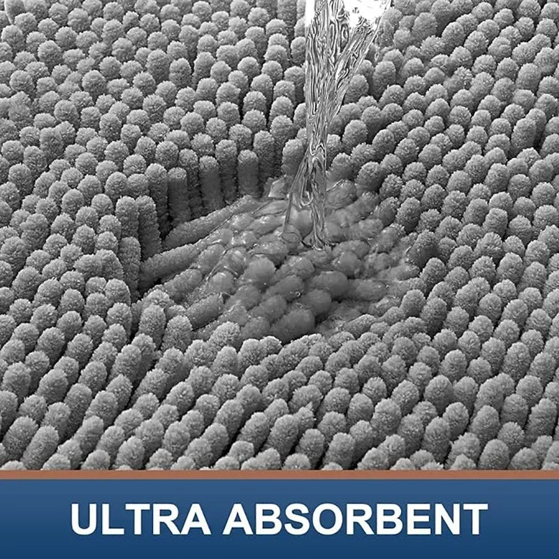 Close-up of a grey, absorbent microfibre dog doormat texture with water being poured onto its tufted surface.