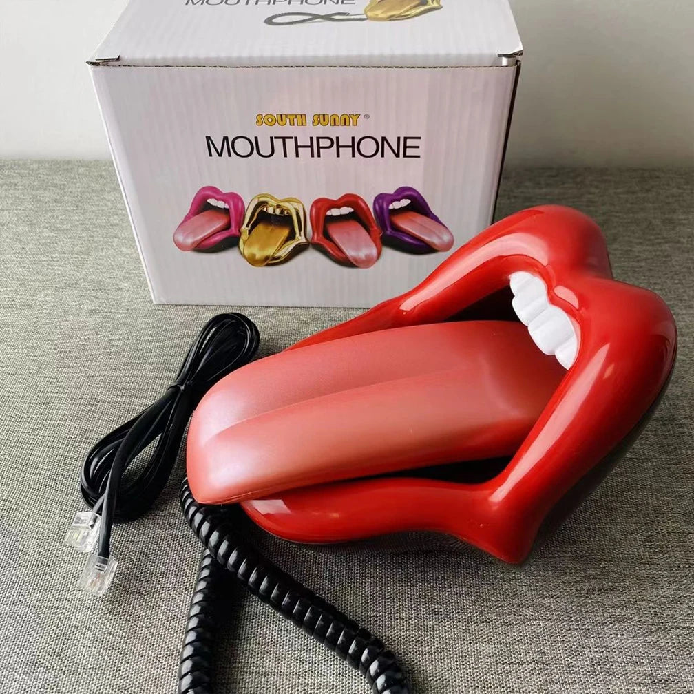 Novelty red lips-shaped corded landline telephone with white teeth and a detachable tongue handset, in original box.