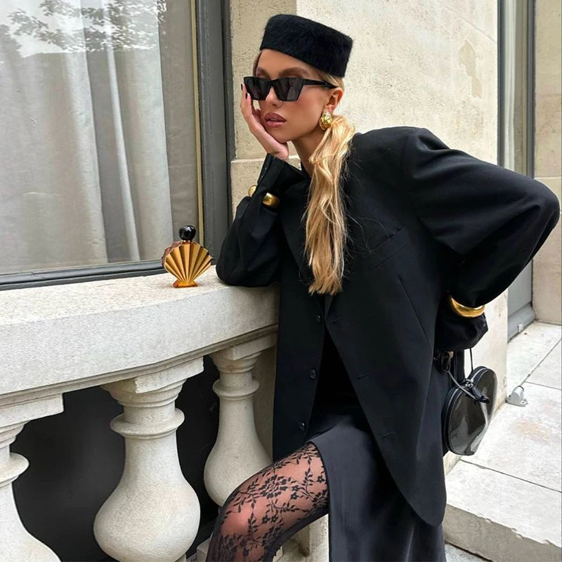 Elegant black wool Hepburn-style bucket hat with a flat top and structured finish.