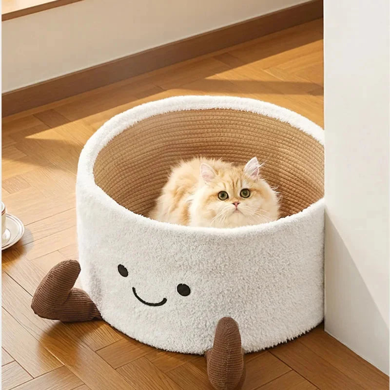 Round white plush cat bed with a smiling face, brown legs, and a tan woven interior holding a cat.