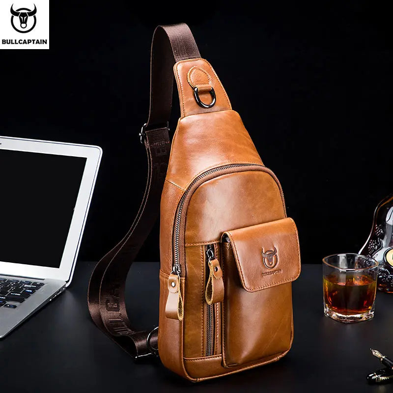 Tan leather crossbody sling bag with a secure zip-up main compartment and front flap pocket on a dark brown strap.