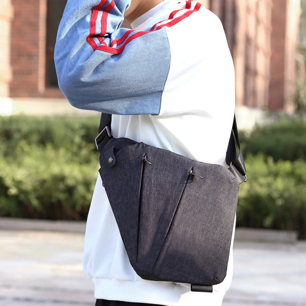Charcoal grey waterproof crossbody chest bag with a slim, ergonomic design and hidden zip pockets.