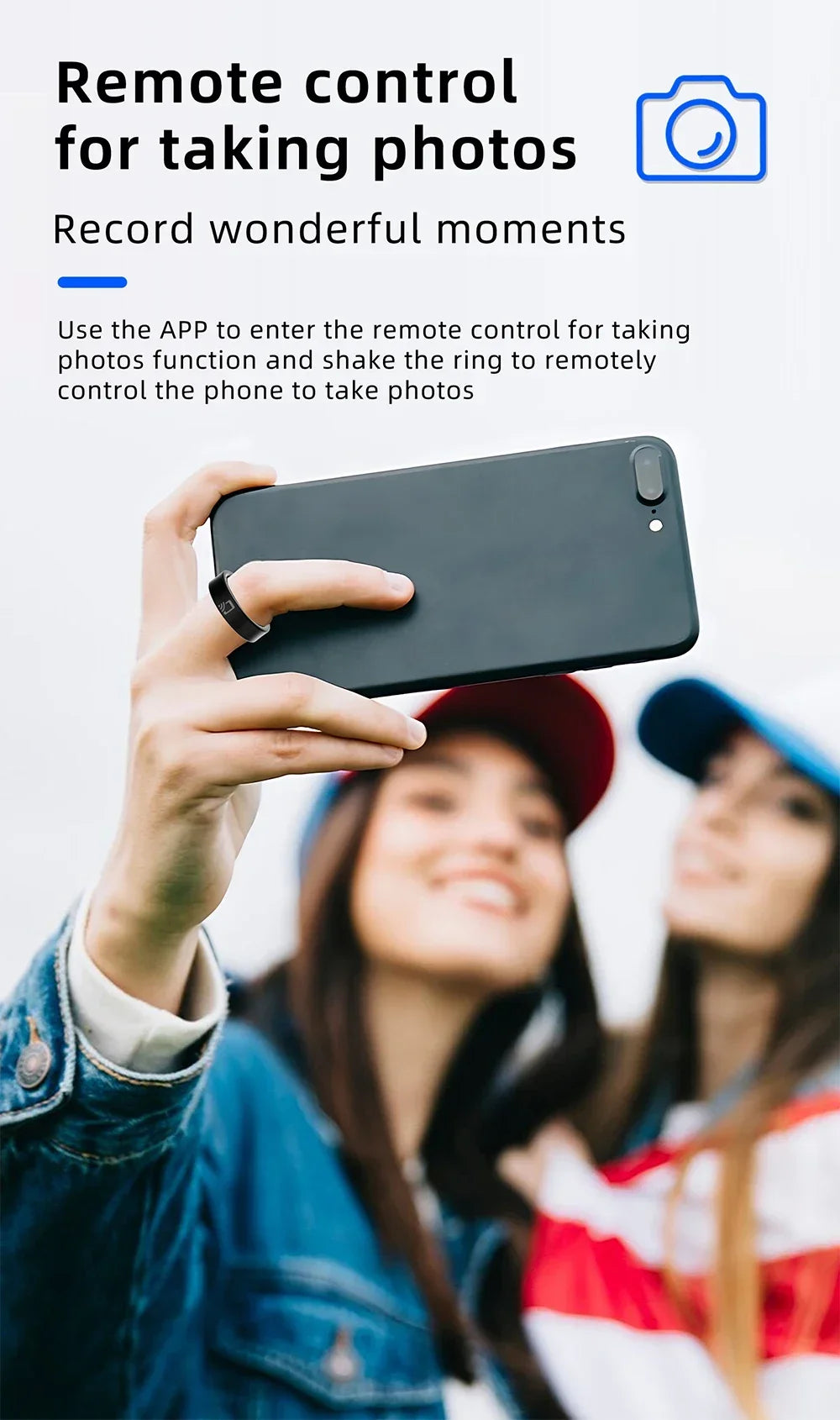 Sleek black NFC smart ring worn on a finger, used as a remote control to take a selfie on a smartphone.