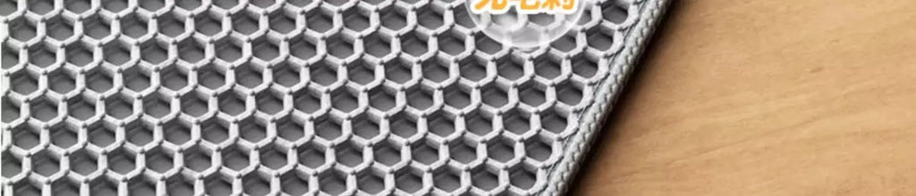 Close-up of a grey, heavy-duty cat litter mat featuring a textured honeycomb design to trap loose litter.