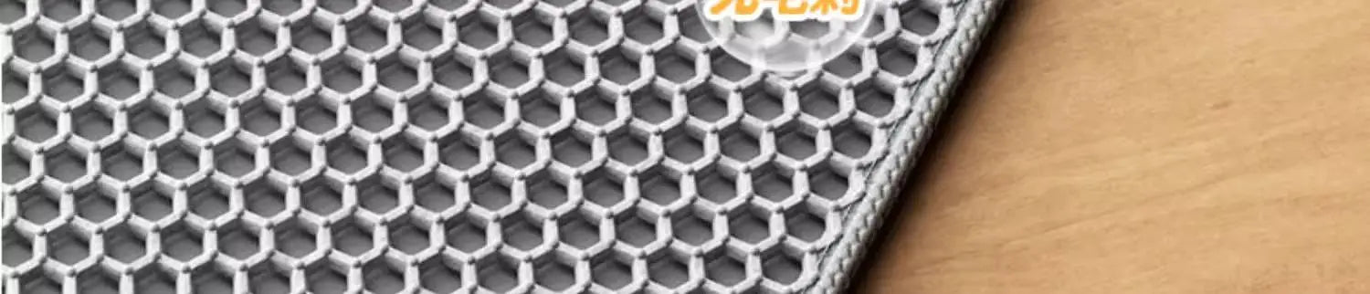 Close-up of a grey, heavy-duty cat litter mat featuring a textured honeycomb design to trap loose litter.