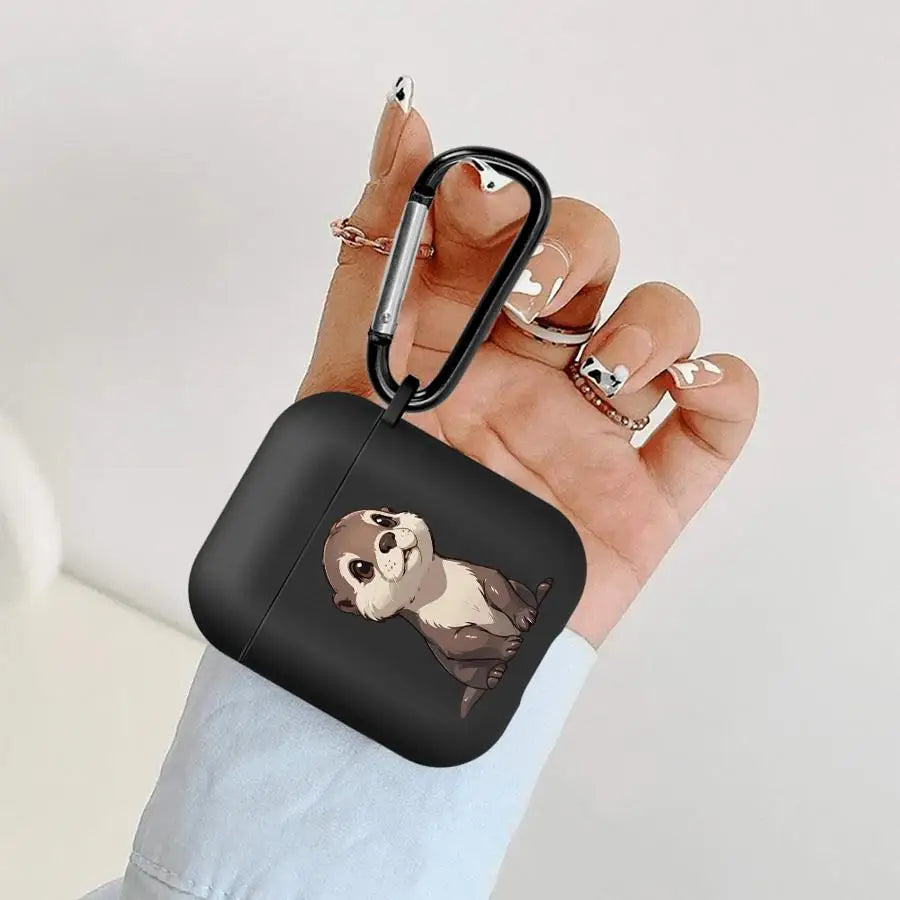 Matte black silicone AirPods case with an otter illustration and black metal carabiner clip.