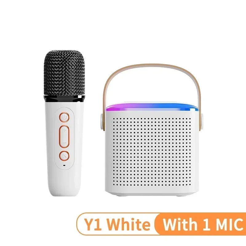 White portable karaoke speaker with carry handle, RGB top lighting, and a matching handheld wireless microphone.