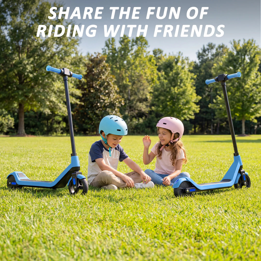 Two children sit on grass with blue and black electric scooters, wearing helmets.