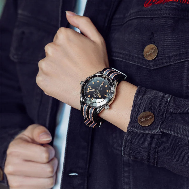 Classic men’s stainless steel watch with a black dial and a striped black and orange nylon fabric strap.