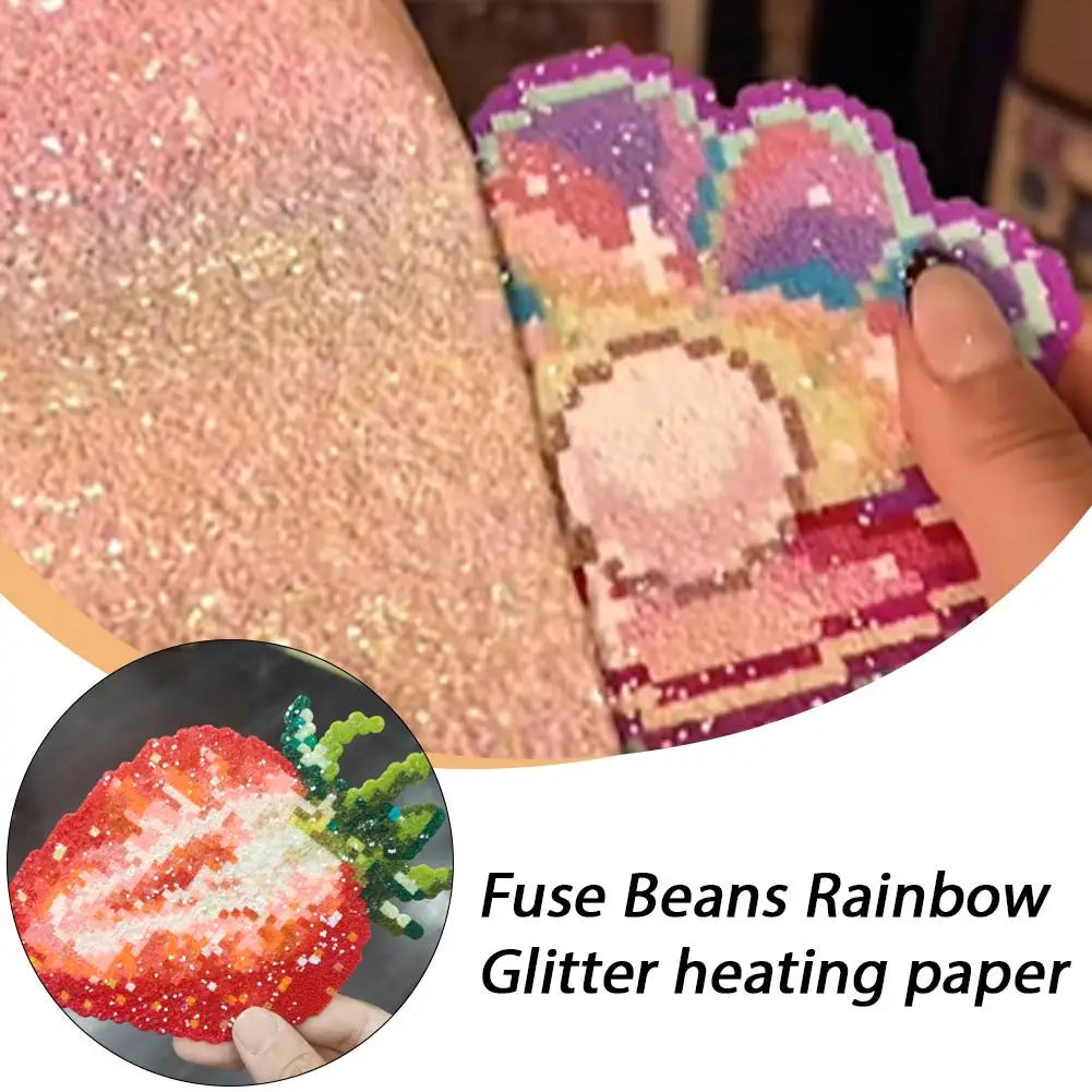 Shiny rainbow glitter fuse bead heating paper used to create colourful, pixelated strawberry and rainbow crafts.