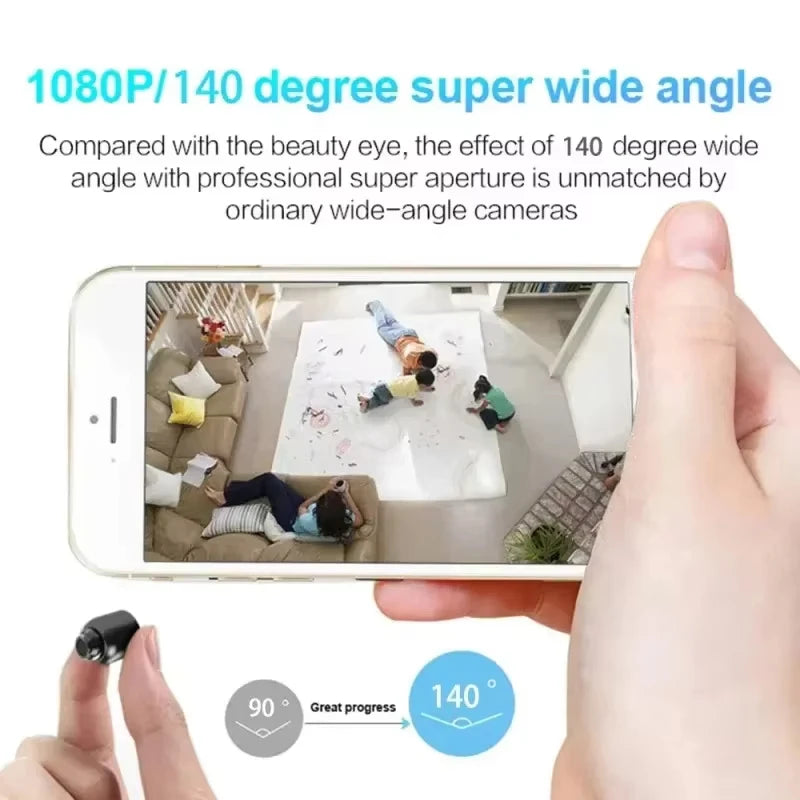 A hand holds a tiny black wireless security camera, with a smartphone displaying its 140-degree wide-angle video feed.