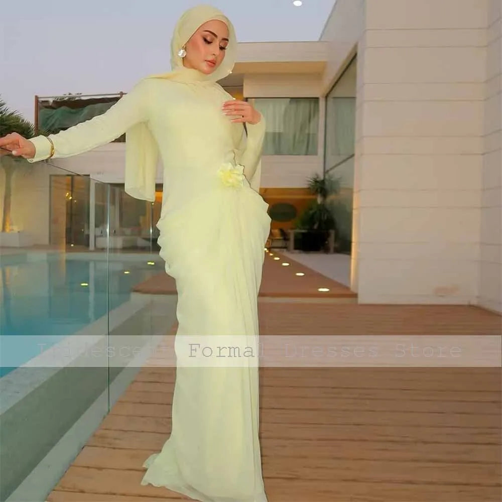 Light yellow long-sleeve mermaid evening gown with high collar, pleated skirt, and a 3D waist flower.