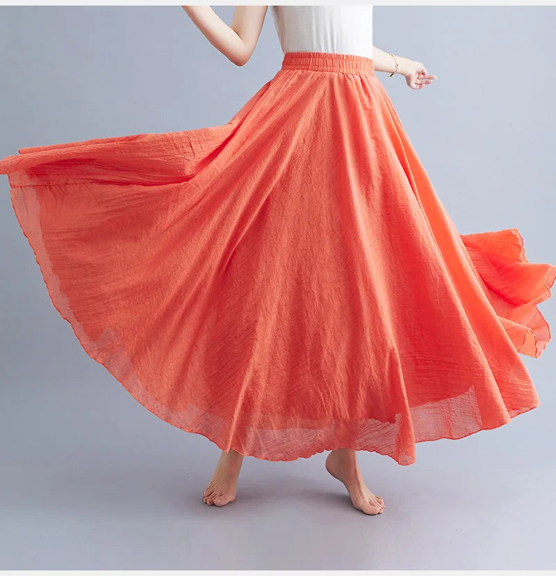 Flowy, coral-orange maxi skirt with a textured, lightweight fabric and comfortable elasticated waistband.