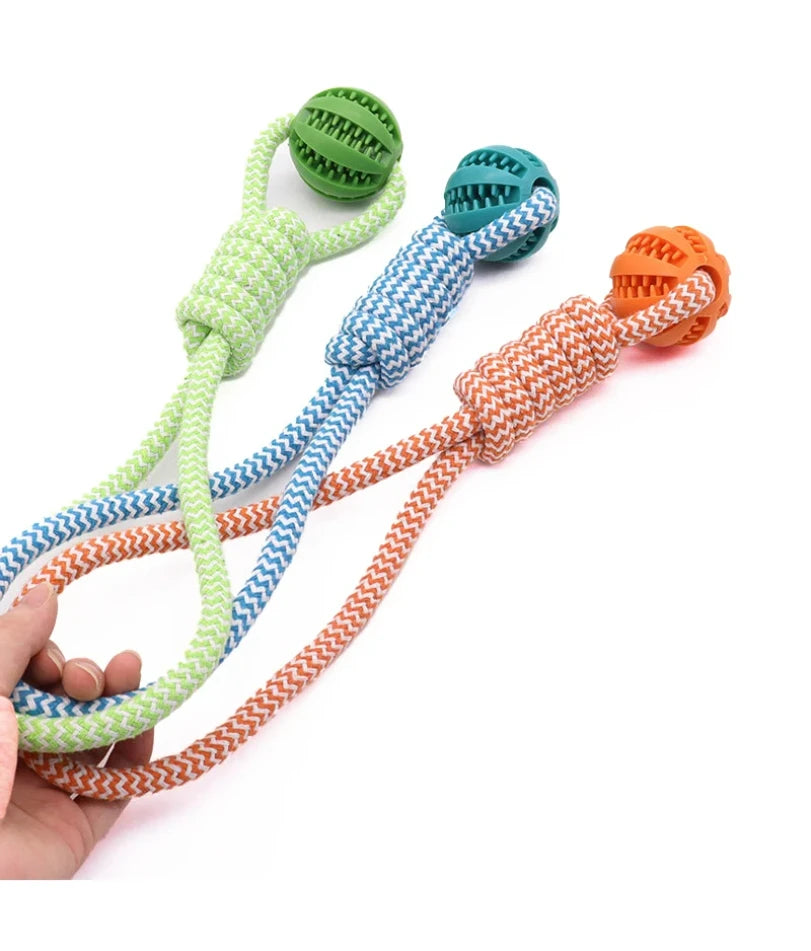 Three dog chew toys with patterned rope handles and textured rubber treat-dispensing balls in green, blue and orange.