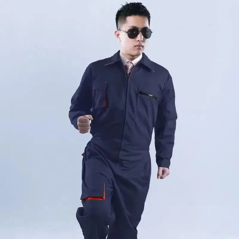 Navy blue work coveralls with long sleeves, zip-up front, multiple pockets, and orange interior accents.
