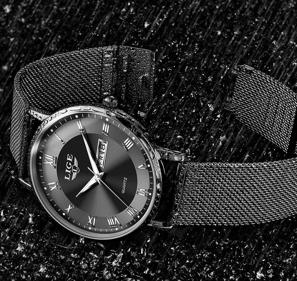Elegant black stainless steel watch with a mesh strap, dark sunray dial, and Roman numeral markers.