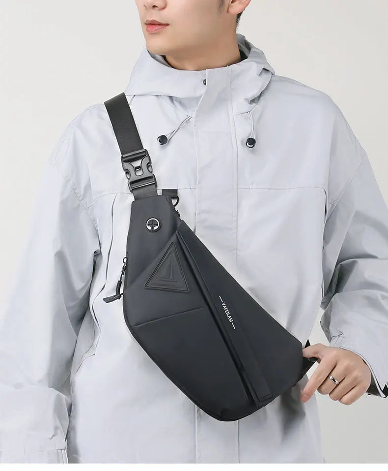 Black men's crossbody sling bag with adjustable buckle strap, sleek minimalist design, and secure zip fastening.