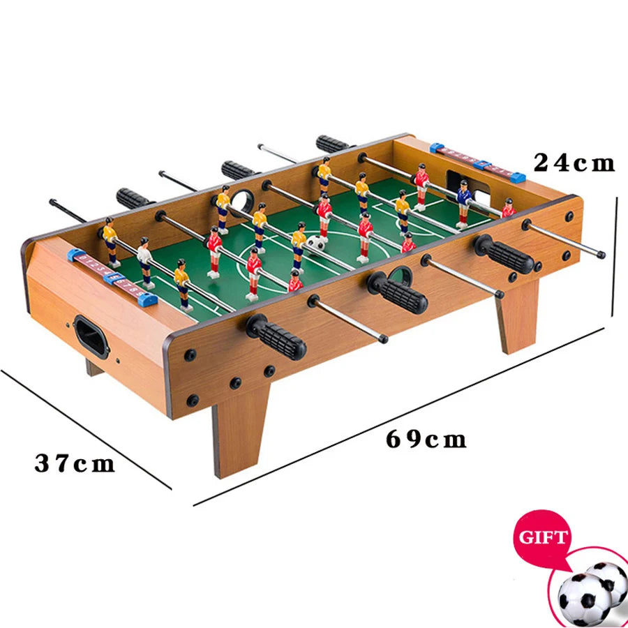 Tabletop foosball game with wood-effect finish, green pitch, score sliders, and two mini footballs. 69x37x24cm size.