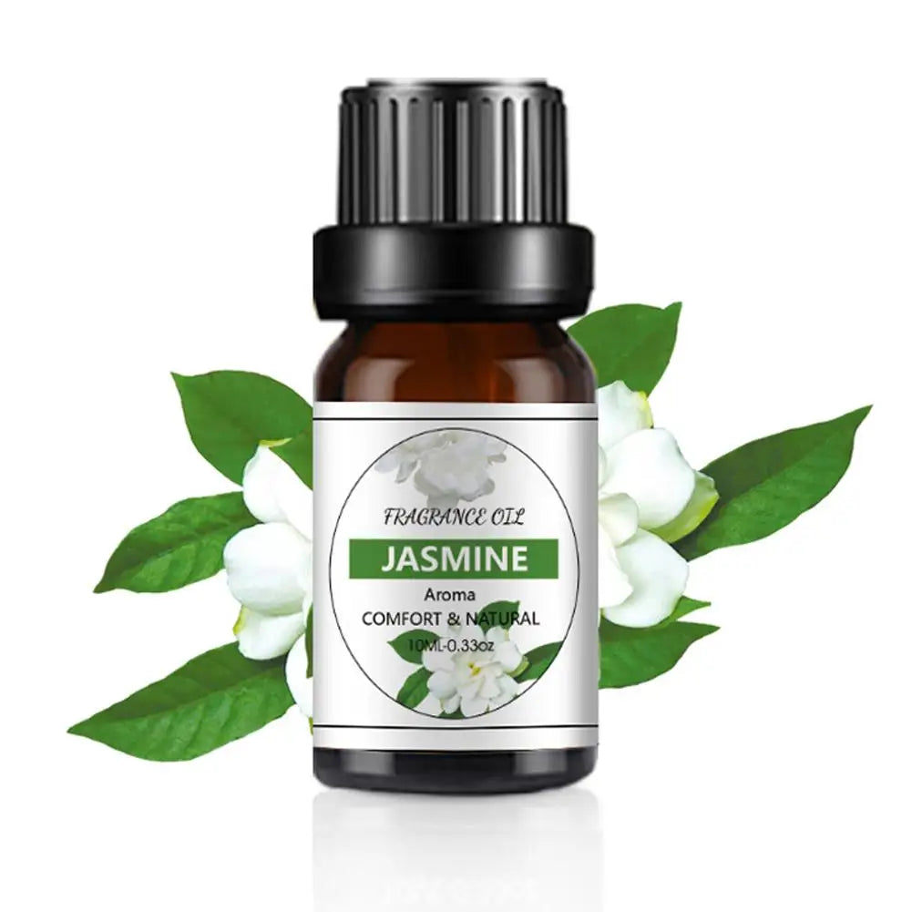 10ml amber glass bottle of Jasmine fragrance oil with a black cap, displayed against fresh jasmine flowers.