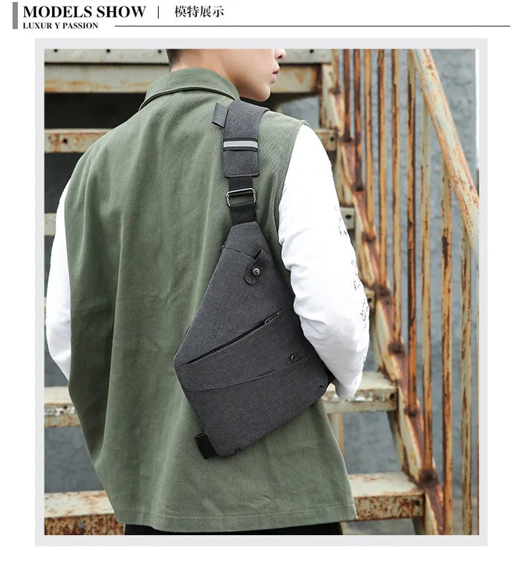 Grey waterproof slim-profile chest bag worn over the shoulder, featuring zipped pockets and an adjustable strap.