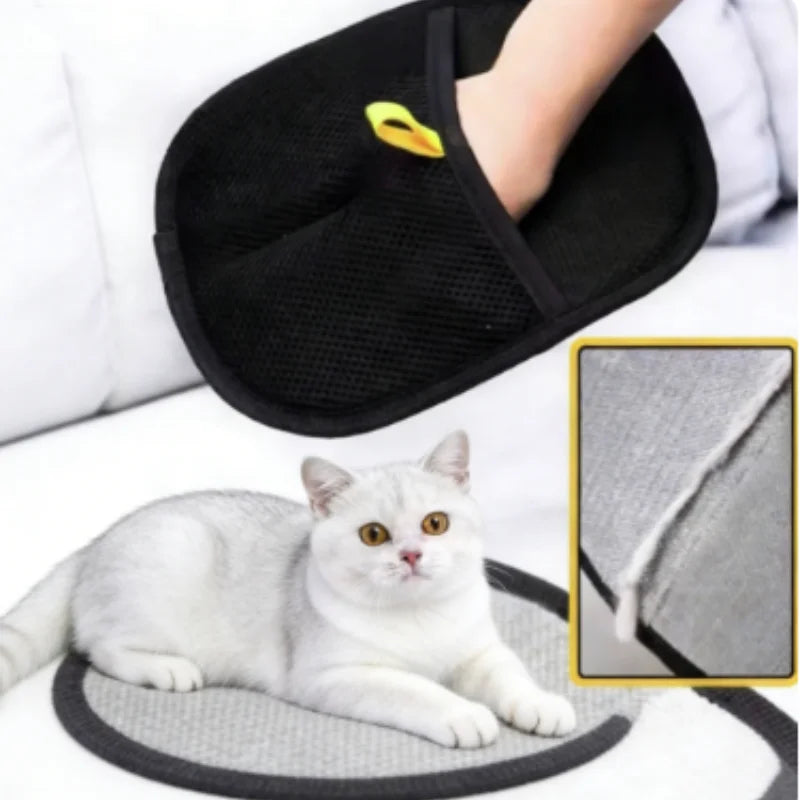Black pet grooming glove with yellow loop, shown removing hair from a grey cat bed with a cat lying nearby.