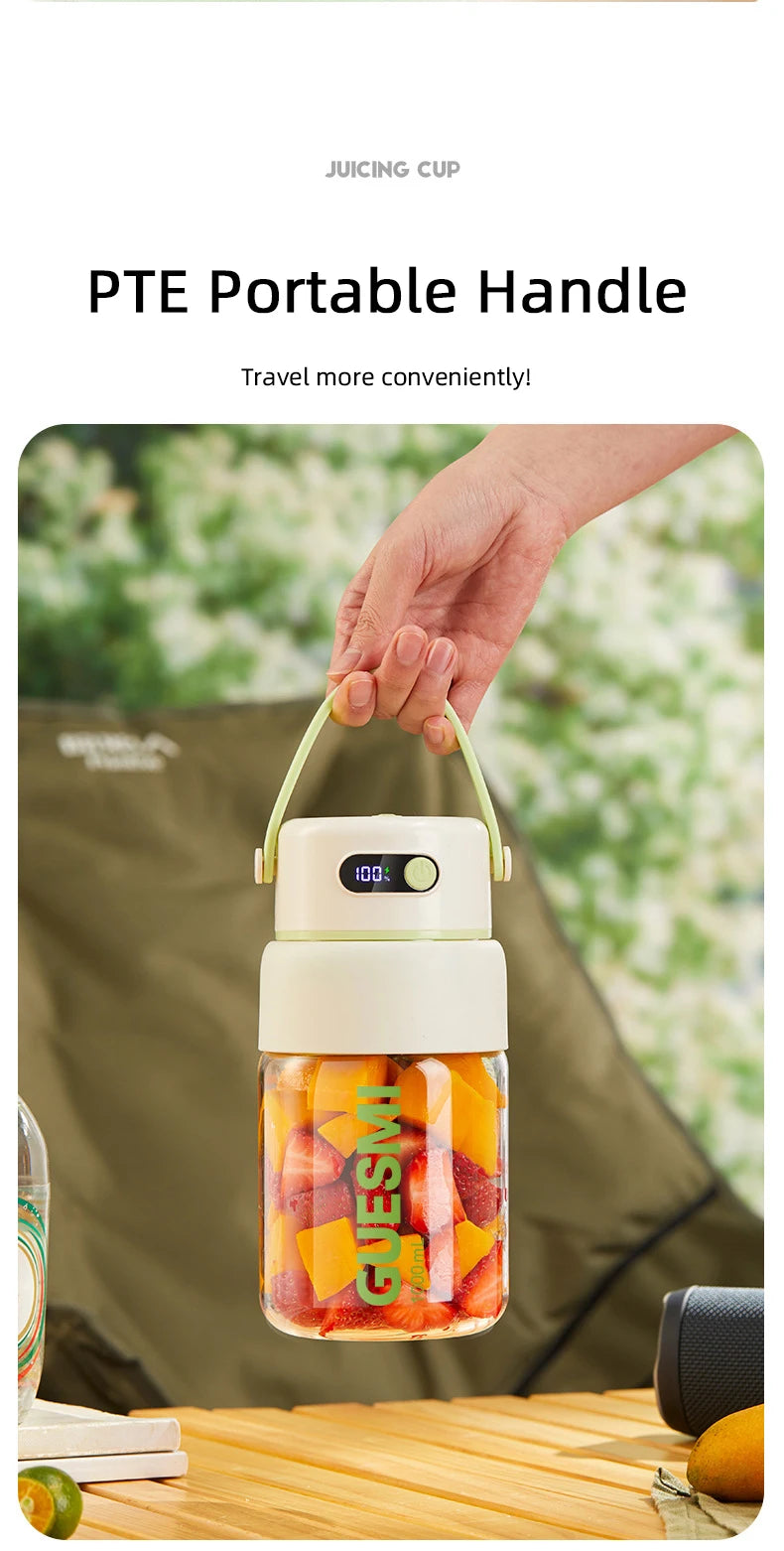 Portable juicer cup with light green handle, white lid featuring a digital battery display, and filled with fruit.
