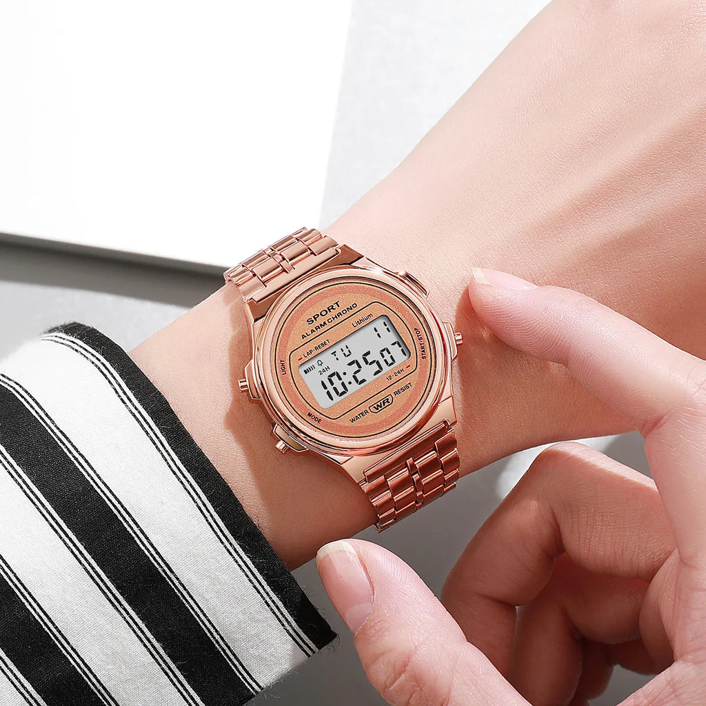 A rose-gold retro-style digital watch with a matching metallic link strap, worn on a wrist.