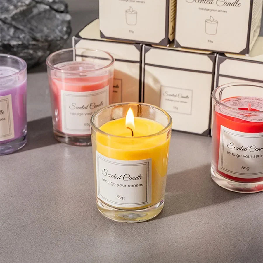 A 55g scented candle in a glass jar, featuring a bright yellow wax and a burning wick, with boxed alternatives nearby.